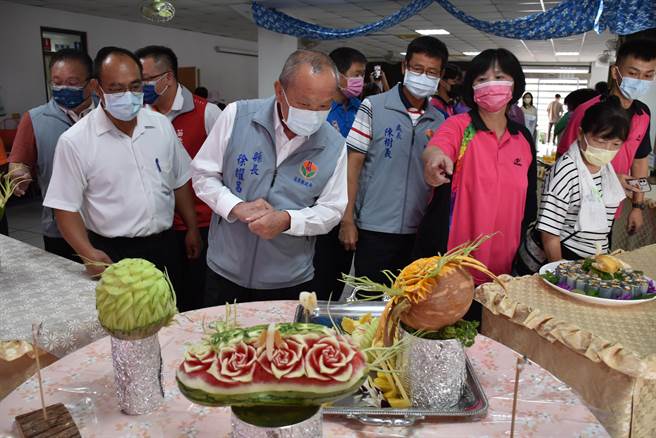 苗栗县长徐耀昌14日赴三湾乡农会促销苗栗高接梨，欣赏果雕作品。（谢明俊摄）