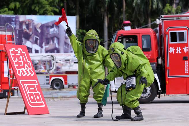 「全民防卫动员暨灾害防救（民安8号）演习」14日在新北市泰山塭仔圳重划区举行，实兵演练模拟共军导弹击中台北港，造成关键设施毁损，化学槽气体外泄，救灾人员穿着全套化学毒灾防护衣，在热区侦测有毒物质是否过量。（黄世麒摄）