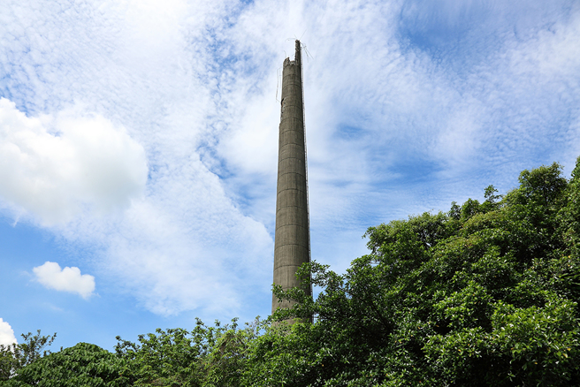 共益砖窑厂拥有两座烟囱，一座高耸入天际，成为大寮的另类地标，另一座则因坍塌，隐身层层绿荫之中。(摄影/Carter)