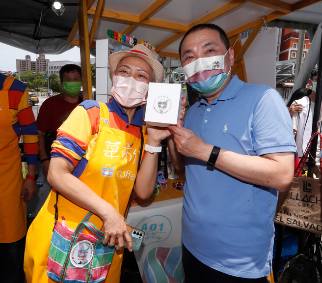 新北市經發局主辦「2022新北好事節」16日登場，侯友宜市長(右)前來視察並與參加新北市各區公有市場特色攤商合影推銷產品。(陳怡誠攝)