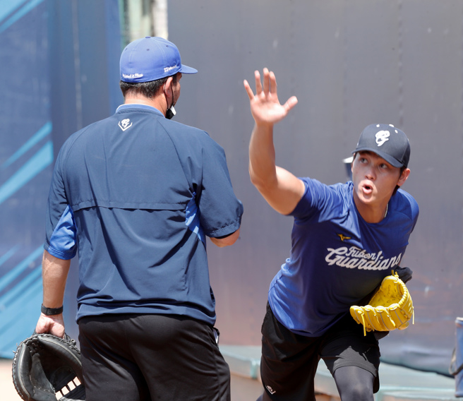 富邦悍將江少慶（右）賽前牛棚練投，投手教練羅曼在一旁緊盯。（資料照，陳怡誠攝）