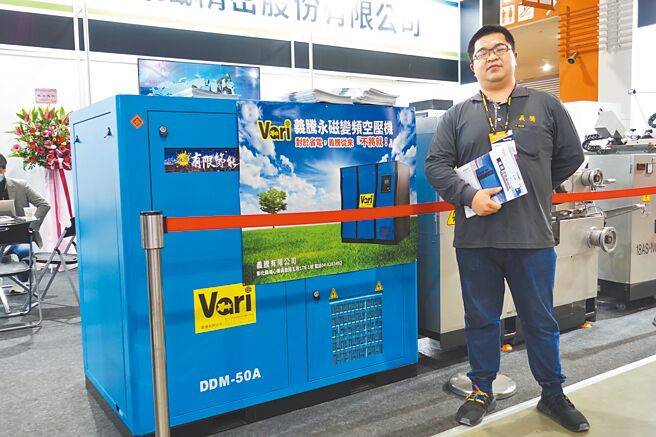 义腾负责人杨承翔和该公司「永磁变频空压机」合影。图／黄俊荣