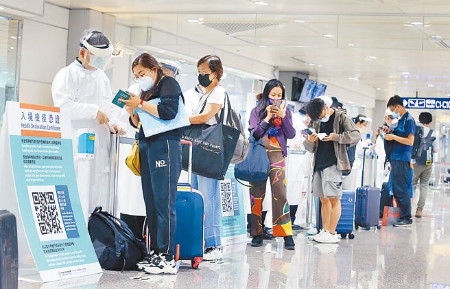 中央流行疫情指挥中心指挥官王必胜22日表示，考量当前国际疫情发展，边境开放时程没有时间表。在桃园机场入境管制区内，防疫人员协助旅客登录入境检疫凭证。（范扬光摄）