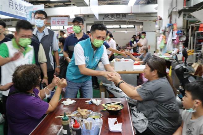 民进党桃园市长参选人林智坚向市场内民眾打招呼。（蔡明亘摄）