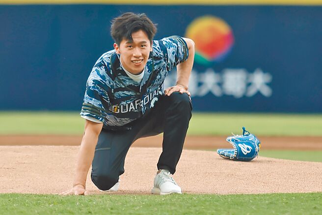 体操「鞍马王子」李智凯应邀为富邦悍将开球，在场中秀出侧翻加后空翻美技，完美落地后露出笑容。（中央社）