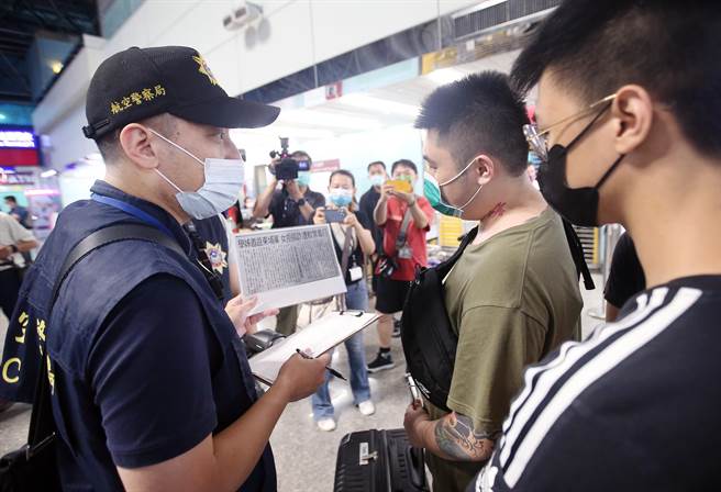 在桃园机场第二航厦出境大厅内，员警向前往柬埔寨的旅客宣导，避免有人受害。（范扬光摄）