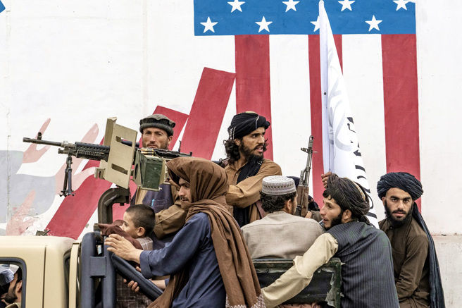 美军与盟军撤离阿富汗即将届满1周年，仍有许多过去为西方政府、公司工作的阿富汗人困在当地，当中有人坦言后悔为西方工作，现在的生活比坐牢还惨。图为塔利班战士在美国大使馆前庆祝重夺政权1周年。（图／美联社）