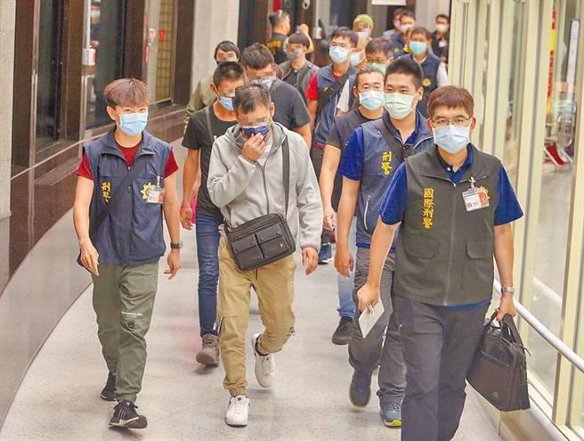 图为近日自柬埔寨回台的9人，其中藏一名帮派要角，走在最前方的即是该帮派诈骗部门成员， 已遭法院羁押。(刑事局提供)