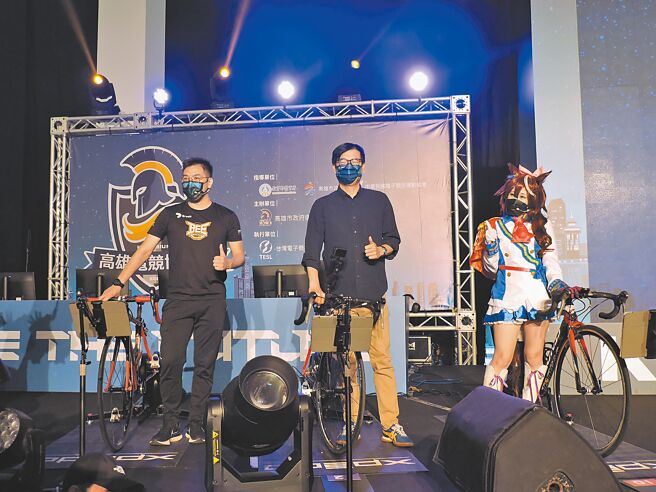 2022高雄电竞博览会暨台湾杯国际自由车电竞争霸赛27日盛大开幕，高雄市长陈其迈（中）与网红娣奇体验自由车电竞。（洪靖宜摄）