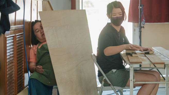 锺欣凌（左）累到躲在木板后睡午觉。（桂田文化艺术基金会提供）