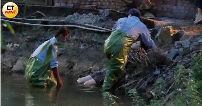 在河边许曦文拍摄打捞画面，看来颇逼真。（图／本刊摄影组）