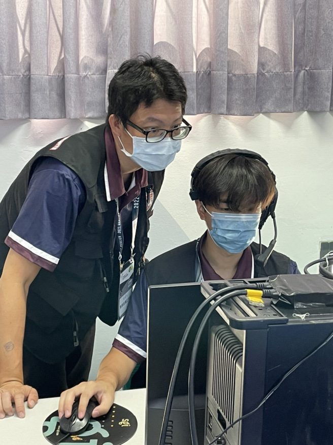 玄奘大学大传系转播组技术指导刘建宏先生，正指导助理导播的操作设定。(照片/玄奘大学提供)