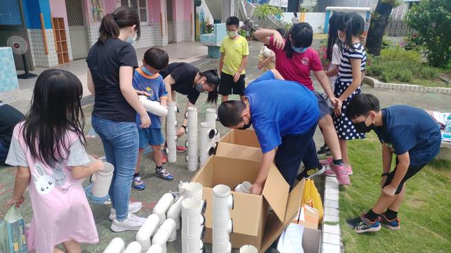 小學生開心的動手做，種菜苗與注水放入小魚，大家期待能享用自己種出來的有機菜，並瞭解自然生態的循環關係鏈。(照片/義守大學提供)。