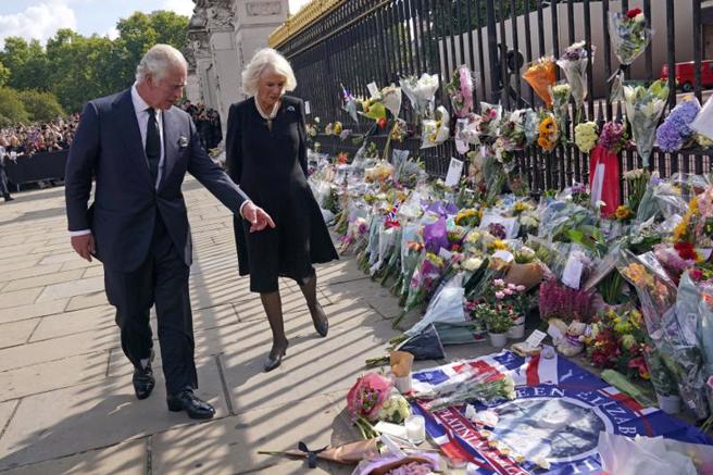 查爾斯三世國王到了白金漢宮，先自看民眾的悼念獻花。(圖/路透社)