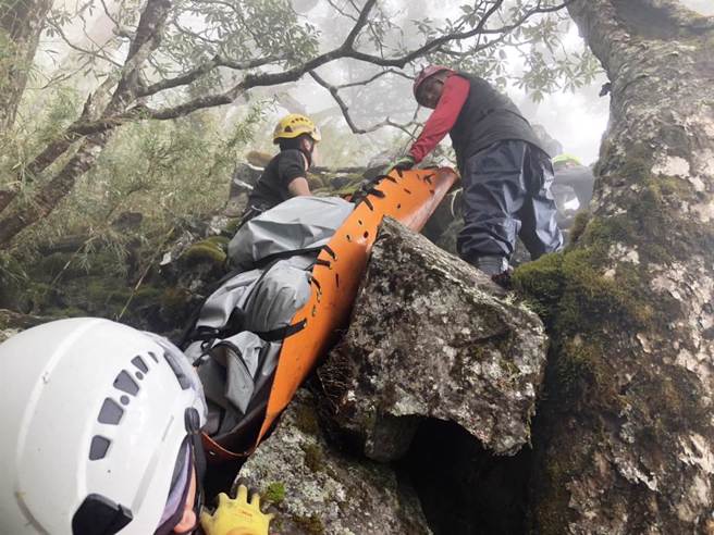 台中市消防人員利用繩索架設固定點，以橫切方式往步道搬移陳姓法官的遺體。（台中市消防局提供）

