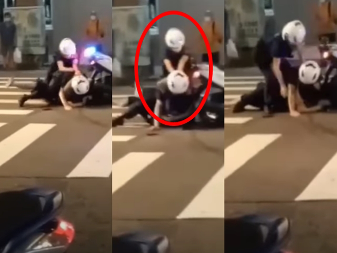 男骑士拒检遭男警压制在地，有民眾拍下过程，发现男警后方的女警神情相当慌张，不断把手压在男警背上，帮忙施加力道，还一度「骑到」男警背上。（翻摄自脸书「爆料公社公开版」）