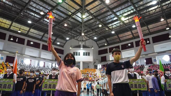 嘉义市中小学联运今天开幕，特奥金牌罗翎瑄（左）与青少年桌球国手戴博钧点燃圣火。（廖素慧摄）