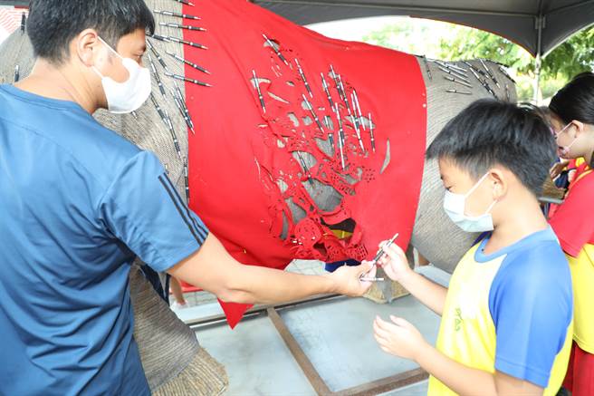 学童拔象徵智慧毛的智慧笔。（吕妍庭摄）