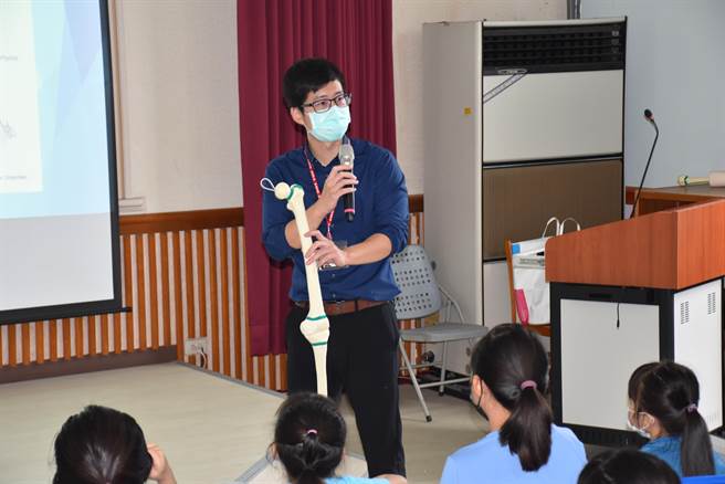 头份为恭医院骨科医师张皓维拿出骨骼模型教导新兴国小学生运动生理学。（谢明俊摄）