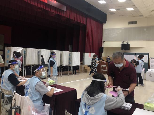 图为台北市信义区公所23日模拟投票，民眾依序排队领票。（资料照/张芷瑜摄）