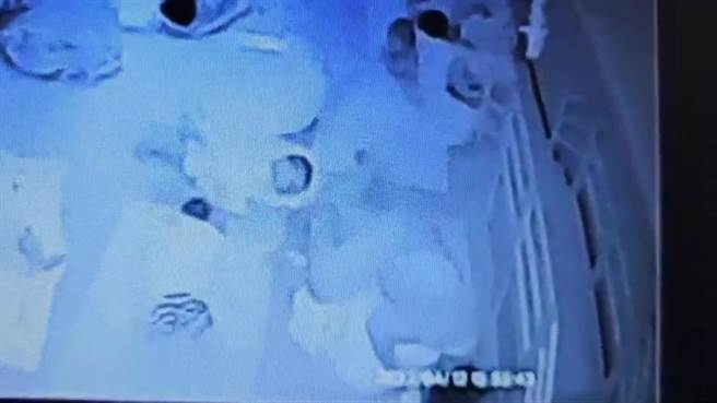 胡姓照护员手脚压住女婴。（石一佑办公室提供）