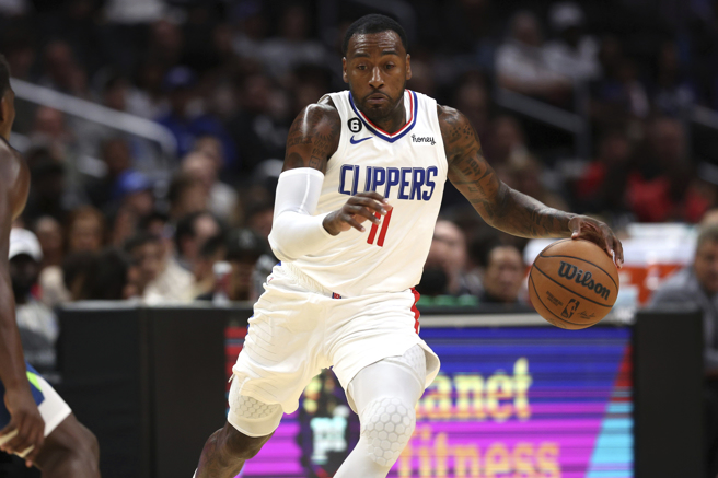 首次代表快艇先发上场，沃尔(John Wall)还是展现出强大的得分能力。(美联社)