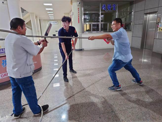 月牙棒阻行器专利持有者陈天（左）示范月牙棒的多功能用途。（台西分局提供）