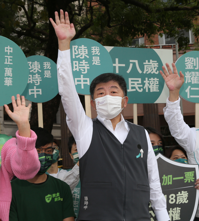 民进党台北市长参选人陈时中13日在中华路与爱国西路口站台，向上班的民眾挥手致意争取支持。（陈君玮摄）