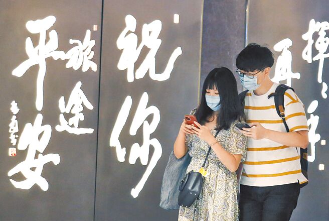 今起國境解封，指揮中心也宣布全球旅遊疫情建議降為第二級警示。圖為12日在桃園機場第一航廈出境管制區內，旅客前往候機室登機。（范揚光攝）