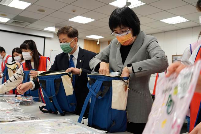 社会局长张锦丽和板信商业银行总经理方嘉男一起帮忙打包。（新北市社会局提供）