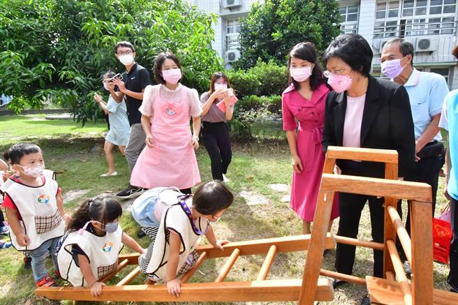 湖西非營利幼兒園及公幼2歲專班的揭牌，縣長王惠美帶著小朋友，走在平衡木上，探索體驗戶外遊戲學習區。（吳敏菁攝）