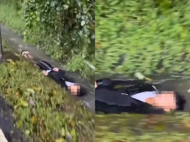 男子走在山路，转头发现山沟内竟有名男子躺在溪水中往下滑；另段画面该男子自拍影片说下大雨想吃早餐，接着就躺在山沟流水中，大喊「吃早餐了」。（翻摄自脸书社团「雾社Create」）