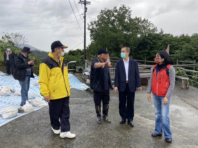 基隆市七堵区东新街北极宫前疑似走山，地层下陷近2公尺，议长蔡旺琏及市议员杨秀玉19日赴现场勘灾，市府铺设防水帆布预防现场塌陷扩大。（张志康摄）