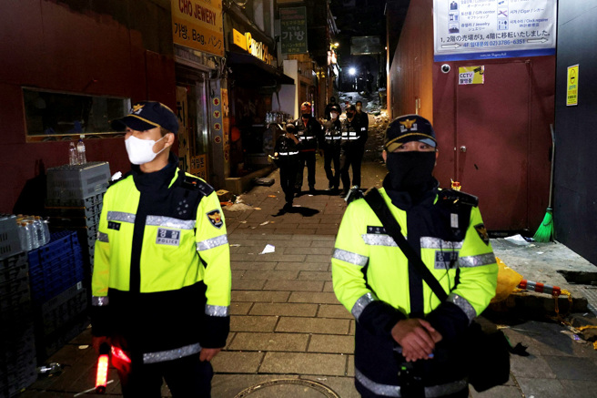 南韓梨泰院10月29日深夜發生踩踏意外後，一名警察在人流中聲嘶力竭地請求民眾回頭，不要再往意外地點走去，堅守崗位的模樣讓南韓網友相當感動。圖為30日南韓警察守在發生意外的窄巷前。（資料照／路透社）