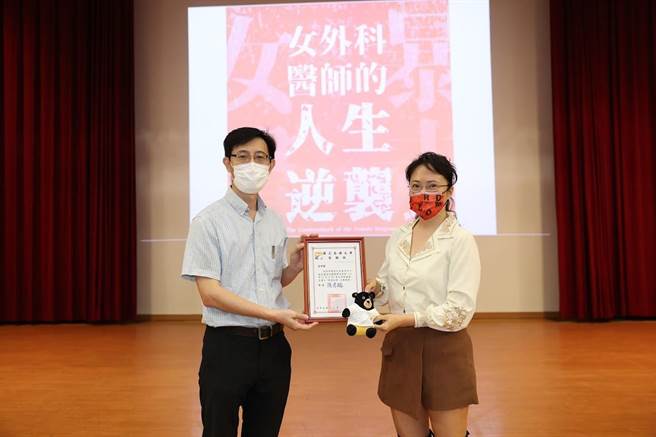 高雄大学推广教育中心主任余进忠（左）1日代表校方颁赠感谢状给「小刘医师」刘宗瑀。（高雄大学提供／林瑞益高雄传真）