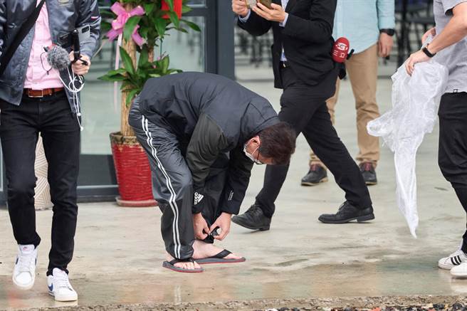 鄭運鵬連2天掃街都遇上大雨，昨天鞋子甚至能倒出水，他笑說今天改穿拖鞋掃街。(蔡依珍攝)