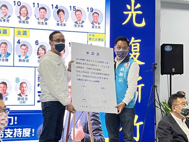 國民黨新竹市長候選人林耕仁（右）11月2日現場簽下承諾書，若當選將捐出市長任內所有薪水給竹市公益團體，要做新竹市「永遠的志工」。（資料照／王惠慧攝）