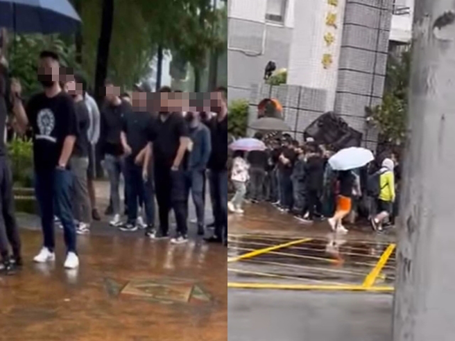 育成高中有大量黑衣人群聚在校门，据了解是该校一名女学生在网路上被警告会遭不利，女学生家长才到校接孩子，而黑衣人只是「刚好约好要一起吃火锅」。（翻摄照片）