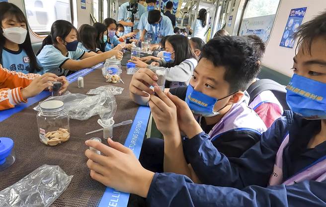 参加科普列车活动的桃园国中与桃园市自主学习3.0实验室自学生在列车上实验如何用砂石将脏水滤清。（邱俪萍老师提供）