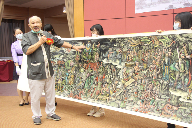 魏滔老师用画来述说故事、传承经典，以擅长的水墨艺术创作，挥洒出自己对「山海经」的热爱。(照片/义守大学提供)