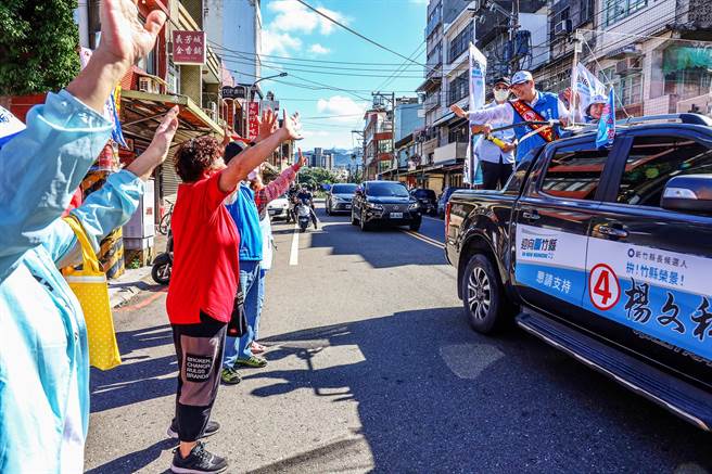 争取县长连任的杨文科在竹北等溪北5乡镇市展开车队扫街拜票，沿途不时有民眾跟他挥手，高喊「冻蒜」。（罗浚滨摄）