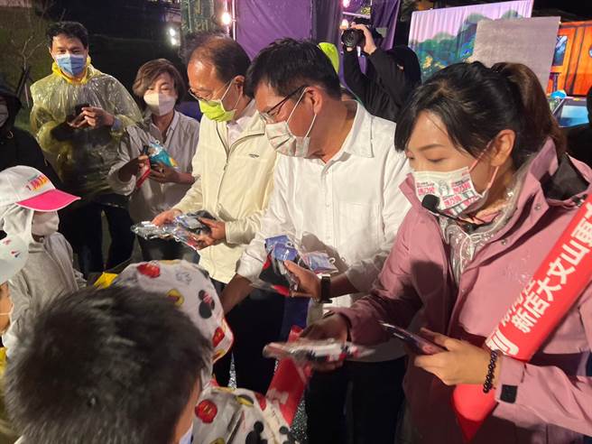 林佳龙发给现场小朋友们小礼物。（王扬杰摄）