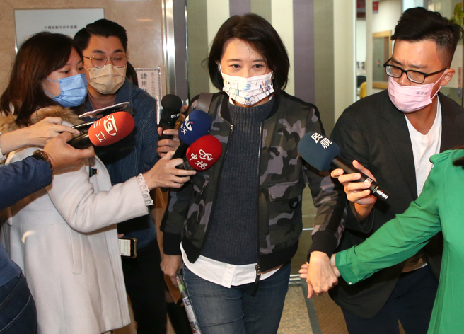 国民党台北市议员王鸿薇（中）2日到中广接受专访，和大家分享她决定接受徵召，参加立法委员补选过程，结束后面对守候的媒体提问，不发一语，快闪离开。（赵双杰摄）