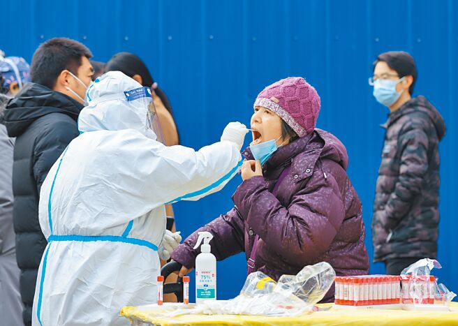 近日多位专家学者指出，未来防疫的目标或将强调「清病不清毒」，对新冠病毒的控制可能不在于「核酸清零」。图为北京一处街头常态化核酸检测点，市民排队接受检测。（中新社）
