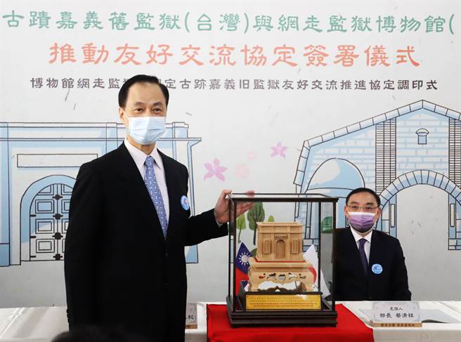 嘉义监狱典狱长吴永杉代表致赠纪念品手工刻制的嘉义旧监狱木雕门楼给日方。（吕妍庭摄）