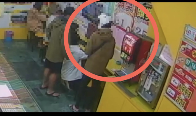 陈男押注完后将彩券放桌上。(戴志扬翻摄)