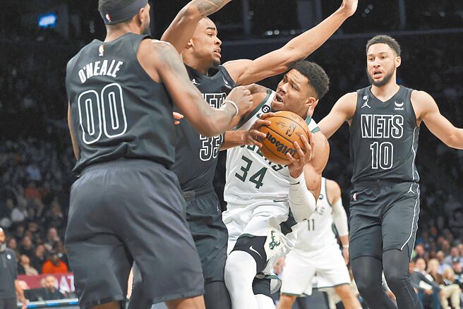 公鹿「字母哥」阿提托康波（中）對籃網身陷重圍。（美聯社）