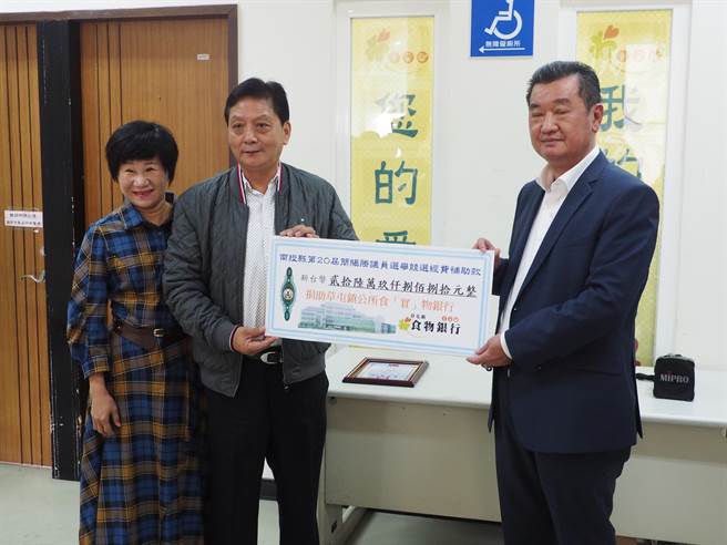 南投县议员简赐胜在妻子陈丽华陪同下，将获得的选举补助款26万9880元捐给草屯食物银行。（民眾提供／杨静茹南投传真）