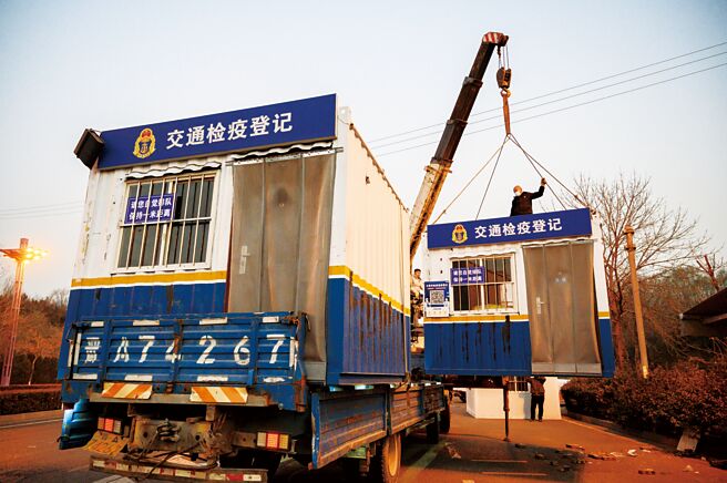 大陆与病毒共存，不再处处查验核酸检测阴性证明，重创核酸检测业。图为山西省太原市拆除交通检疫登记简易房。（中新社）