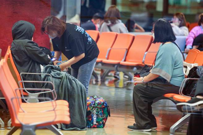 左方二位旅客其一疑似为闪燃的行动电源持有者。（陈麒全摄）